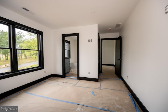 unfurnished bedroom featuring ensuite bathroom