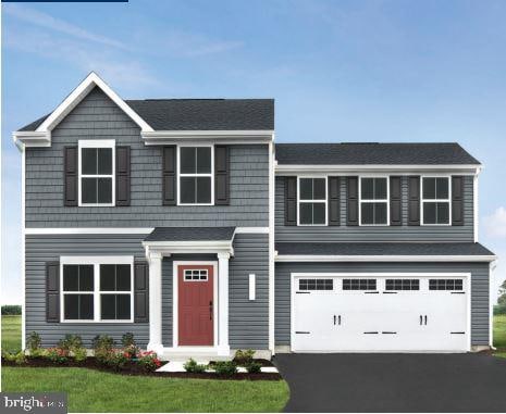 view of front of house featuring a front yard and a garage