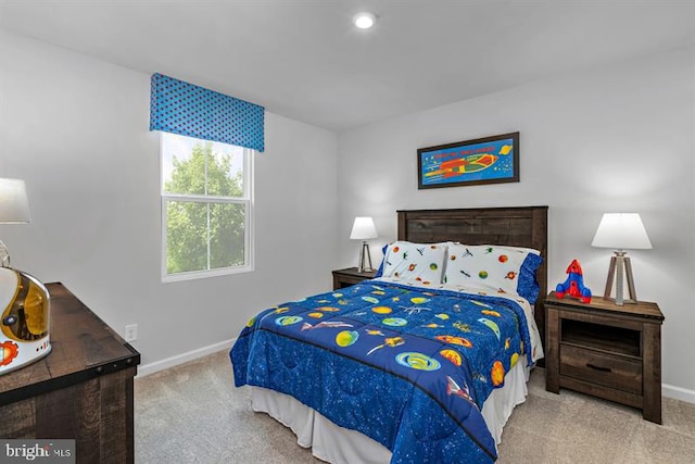 bedroom featuring light carpet