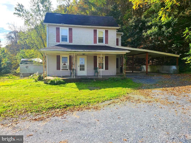 view of front of home featuring a front lawn, a porch, and a carport