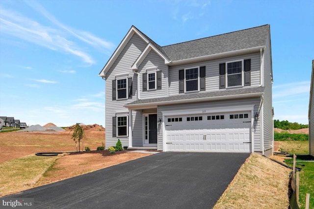 view of front of property with a front lawn and a garage