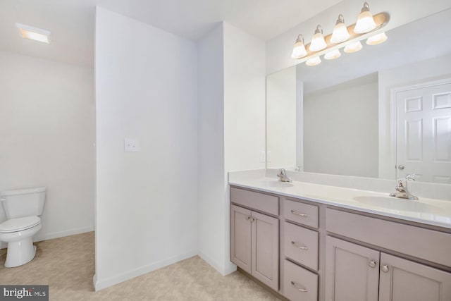 bathroom with tile floors, dual sinks, vanity with extensive cabinet space, and toilet