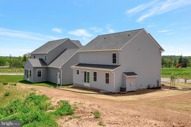 rear view of house featuring central AC