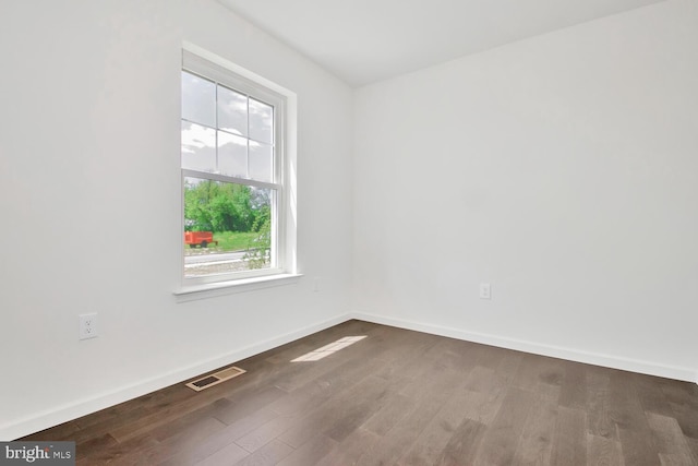 empty room with dark hardwood / wood-style floors