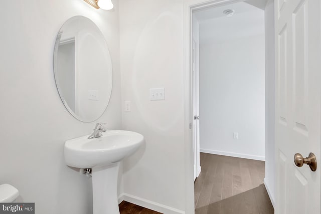 bathroom featuring toilet and wood-type flooring