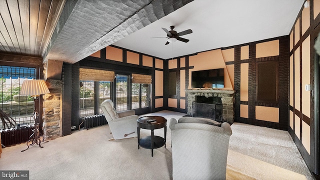 1717 Woodland Rd, Abington, PA 19001 - interior space featuring radiator heating unit, ceiling fan, light colored carpet, and a stone fireplace