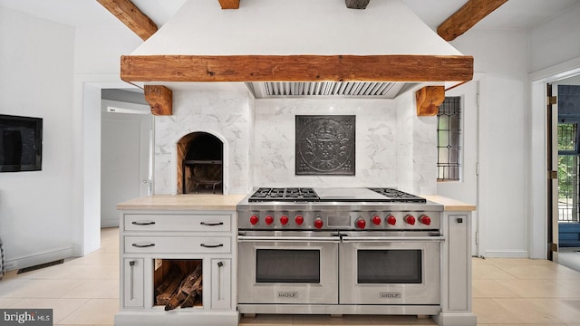 1717 Woodland Rd, Abington, PA 19001 - kitchen featuring light tile flooring, beam ceiling, white cabinetry, and range with two ovens