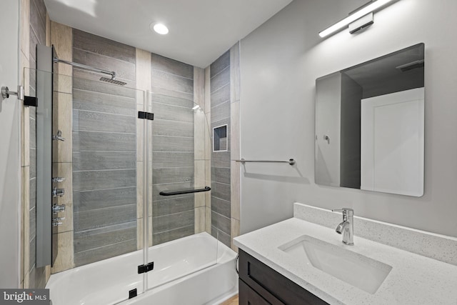 bathroom featuring vanity and enclosed tub / shower combo