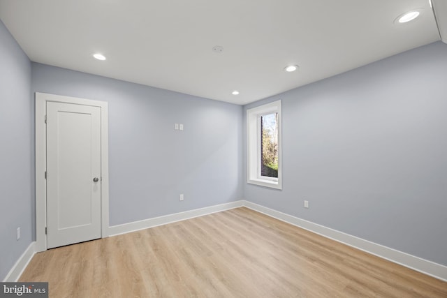 unfurnished room with light wood-type flooring