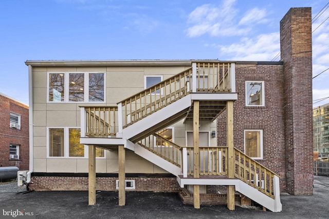 rear view of property with a wooden deck