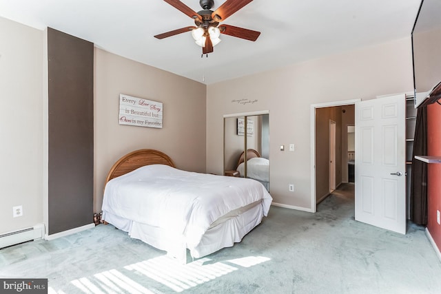 bedroom with ceiling fan, a closet, light colored carpet, and a baseboard heating unit