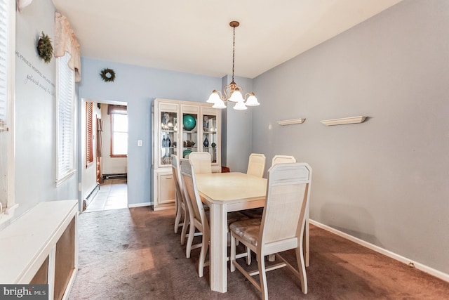 dining space with a chandelier, a baseboard radiator, and dark colored carpet