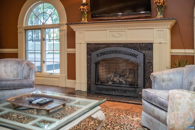 interior space featuring a high end fireplace, tile flooring, and a wealth of natural light