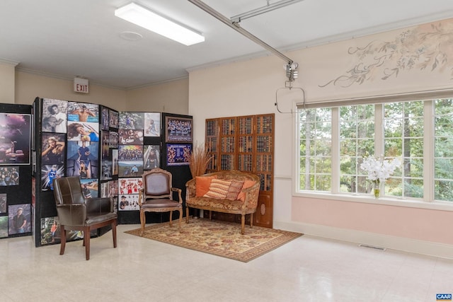 sitting room featuring ornamental molding, a notable chandelier, and light tile floors