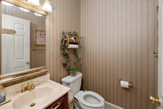 bathroom with toilet and vanity