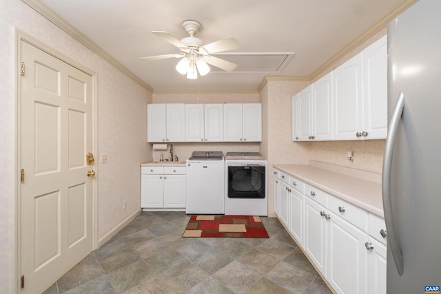 kitchen with white cabinetry, ceiling fan, stainless steel fridge, washer and clothes dryer, and ornamental molding