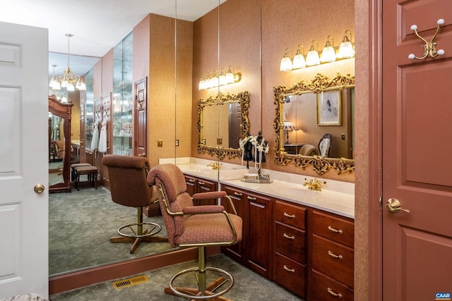 bathroom with a chandelier and vanity