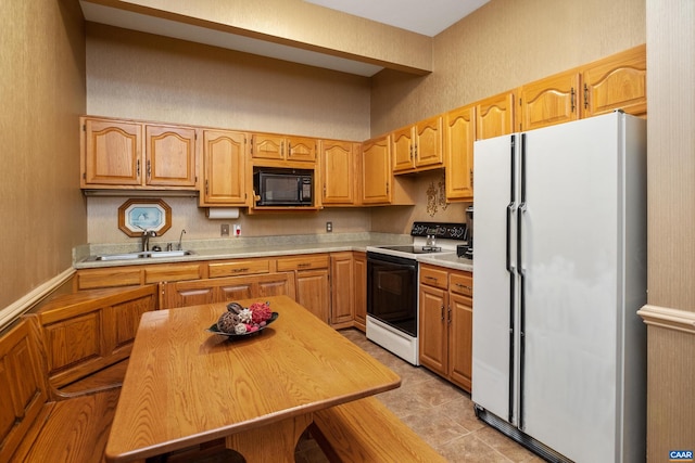 kitchen featuring white appliances, sink, and light tile floors