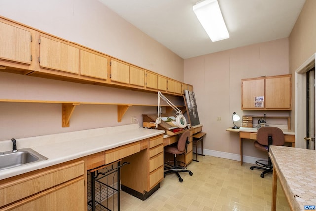 tiled home office with built in desk and sink