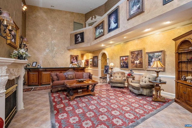 living room with light tile floors and a towering ceiling