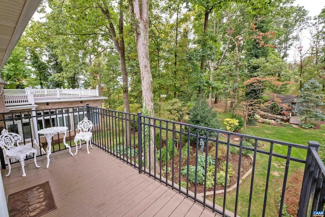 wooden deck with a lawn