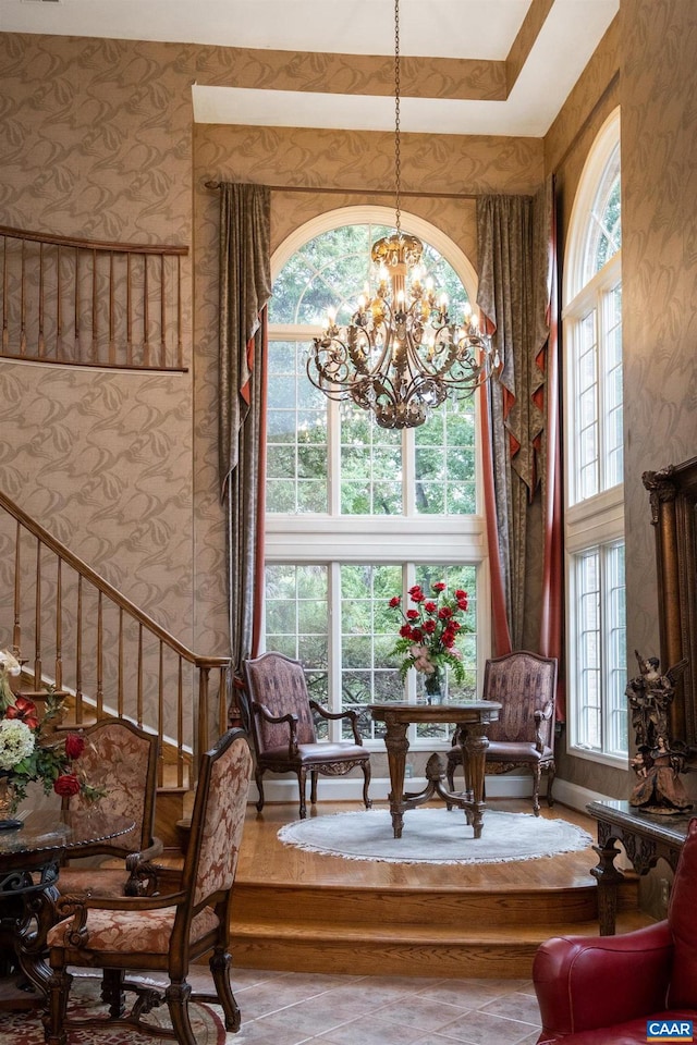 living area featuring a chandelier and a high ceiling