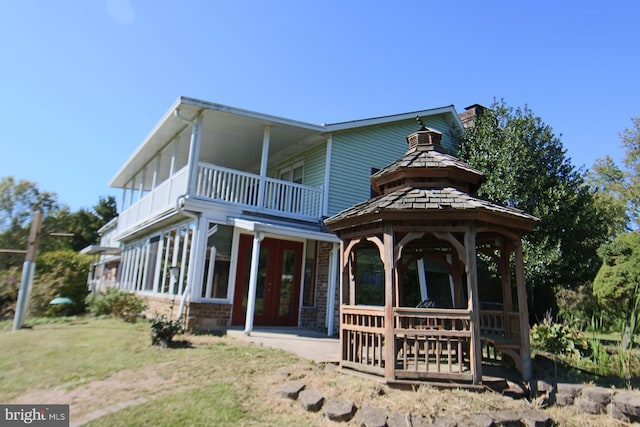 back of property with a balcony