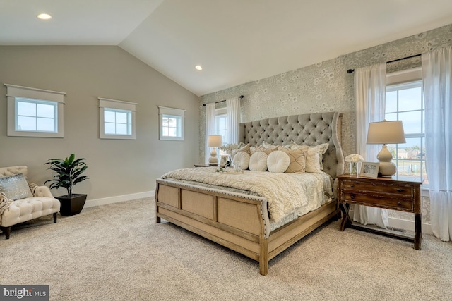 bedroom with light carpet and lofted ceiling