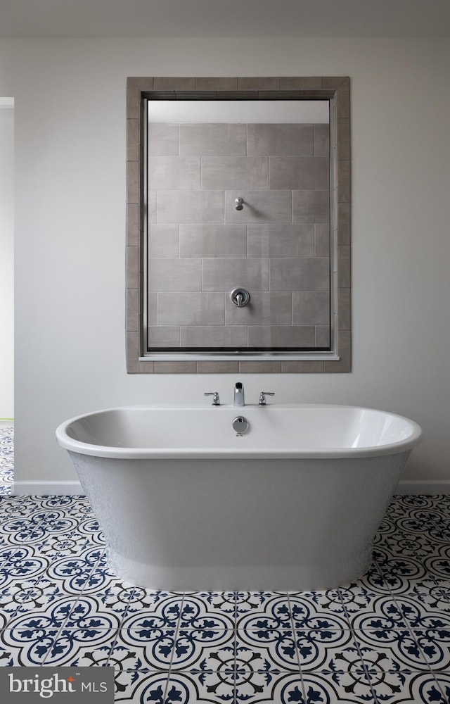 bathroom with a bathing tub and tile patterned floors