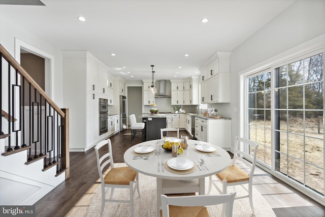 dining area featuring sink and dark wood-type flooring