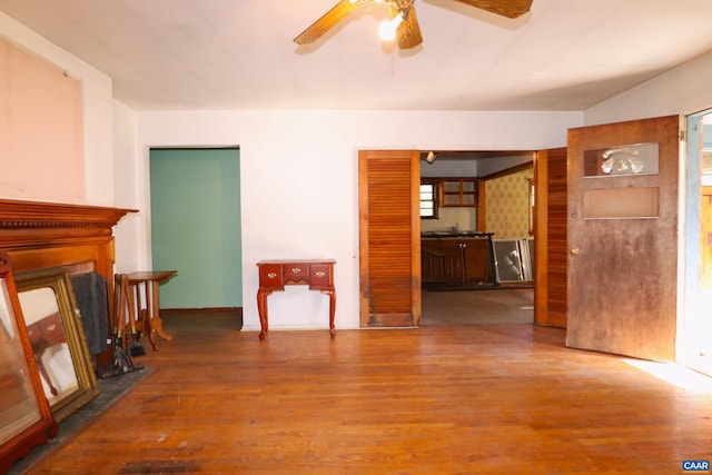 unfurnished living room with hardwood / wood-style floors and ceiling fan