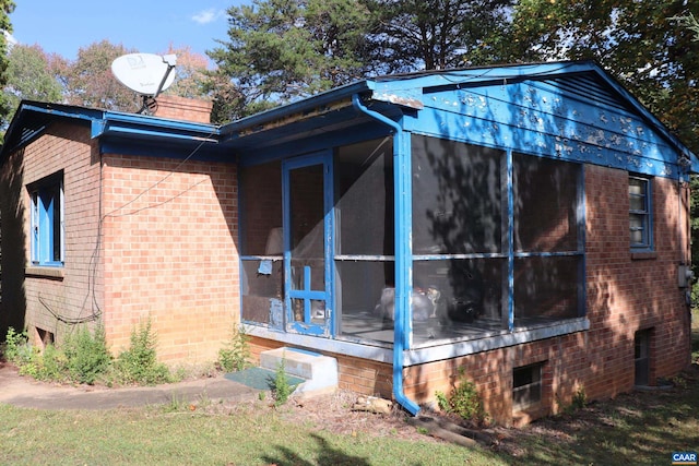 view of home's exterior with a sunroom