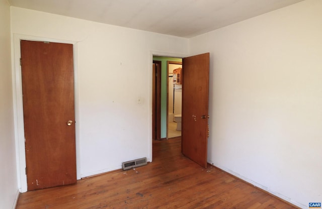 spare room with dark wood-type flooring