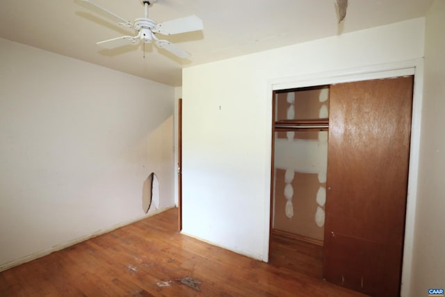 unfurnished bedroom with hardwood / wood-style flooring, a closet, and ceiling fan