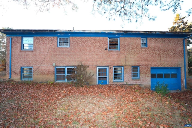 rear view of house with a garage