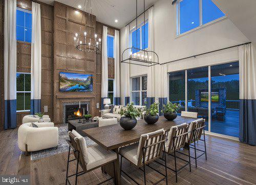 dining area featuring dark hardwood / wood-style flooring, a high ceiling, and a chandelier