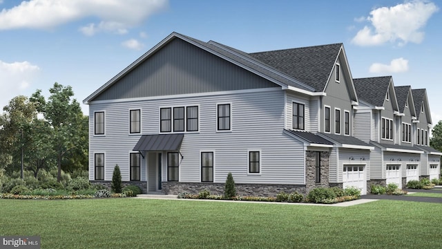 view of front of home featuring a front yard and a garage