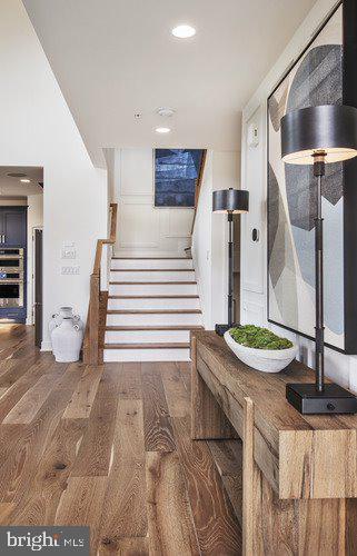 staircase with dark hardwood / wood-style flooring