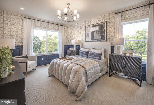 bedroom with light carpet and an inviting chandelier