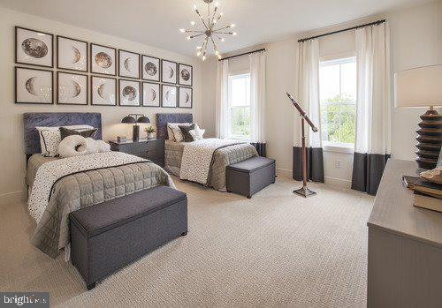 carpeted bedroom featuring an inviting chandelier and multiple windows