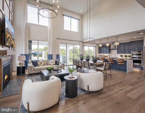 living room featuring dark hardwood / wood-style flooring, a notable chandelier, and a high ceiling