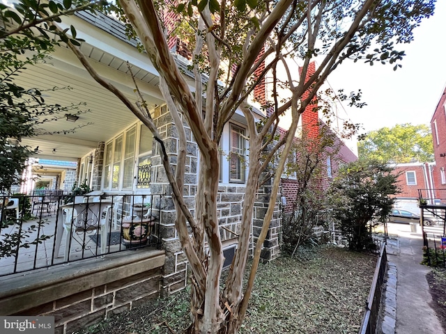 view of side of home featuring a porch