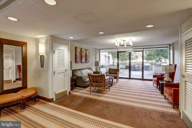 living room featuring a wall of windows and carpet