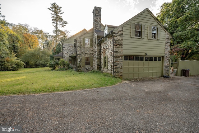 view of front of property with a front lawn and a garage