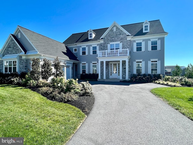 994 Valley Crossing Dr, Lititz, PA 17543 - view of front of property with a balcony, a front yard, stone siding, and aphalt driveway