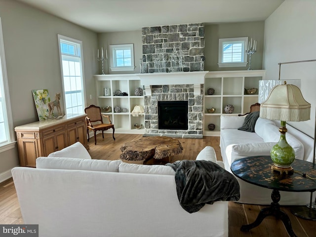 994 Valley Crossing Dr, Lititz, PA 17543 - living area featuring a fireplace, wood finished floors, and a healthy amount of sunlight