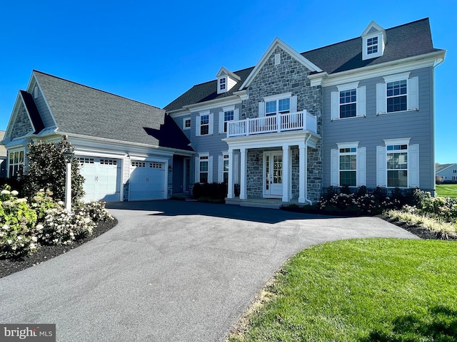 994 Valley Crossing Dr, Lititz, PA 17543 - colonial house featuring stone siding, a balcony, driveway, and an attached garage