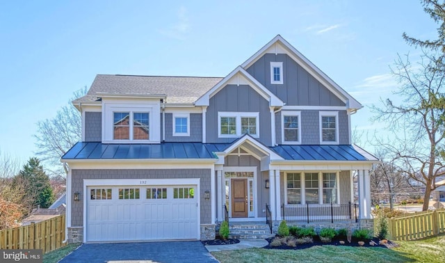 craftsman-style house with covered porch, a front lawn, and a garage