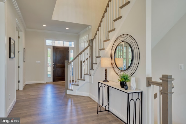 entryway featuring ornamental molding and light wood-type flooring