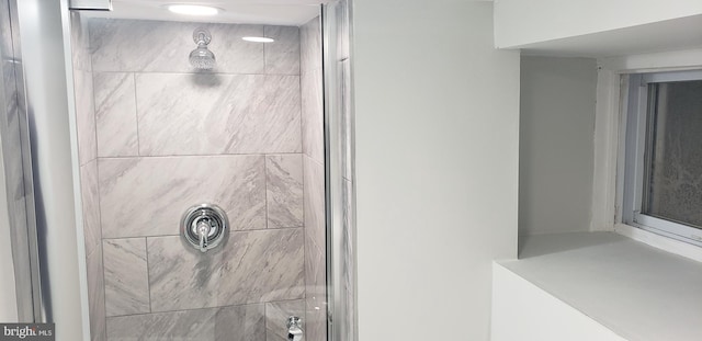 bathroom with a tile shower